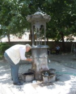 Old man drinking from the city fountain in Tokat